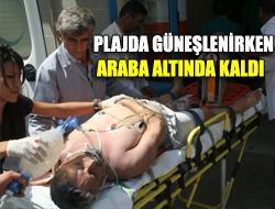 Plajda güneşlenirken araba altında kaldı